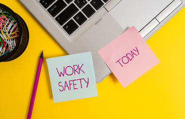 Text sign showing Work Safety. Business photo text policies and procedures in place to ensure health of employees Trendy metallic laptop sticky notes clips container pencil colored background