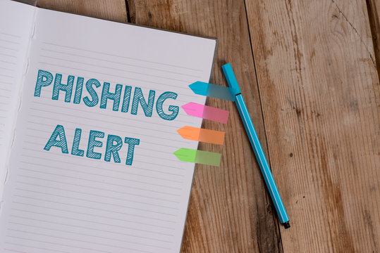 Conceptual hand writing showing Phishing Alert. Concept meaning aware to fraudulent attempt to obtain sensitive information Striped notebook colored arrow banners ballpoint wooden background