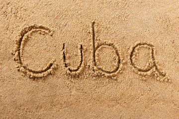 Cuba word written in sand on a sunny cuban summer beach holiday vacation travel destination sign writing message photo