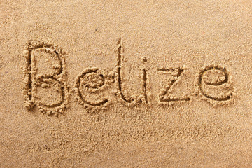 Belize word written in sand sign writing drawing drawn on a sunny summer beach holiday vacation travel destination message photo