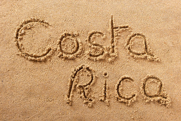 Costa Rica word written in sand sign writing drawing drawn on a sunny summer beach holiday vacation...