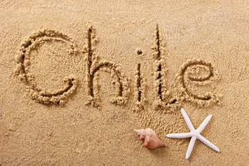 Chile word written in sand sign writing drawing drawn on a sunny summer beach with starfish holiday vacation travel destination message photo