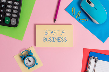 Conceptual hand writing showing Startup Business. Concept meaning Engaging to a New Venture Fresh Trading and Selling Mouse calculator sheets marker clipboard clock color background