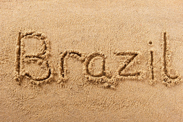 Brazil word written in sand sign writing drawing drawn on a sunny summer beach holiday vacation travel destination message photo