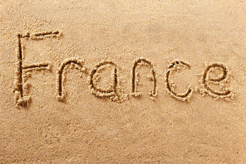 France word written in sand sign writing drawing drawn on a sunny french summer beach holiday vacation travel destination message photo