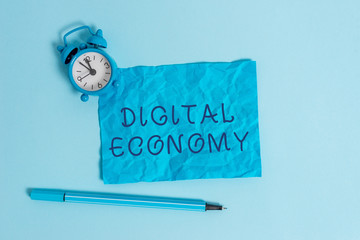 Writing note showing Digital Economy. Business concept for worldwide network of economic activities...