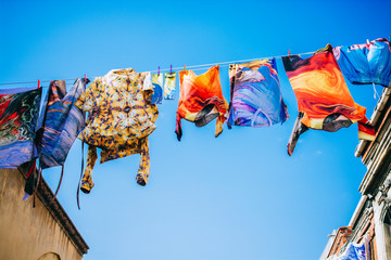 Clothes hanging from a clothes line rope in a street