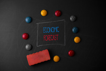 Conceptual hand writing showing Economic Forecast. Concept meaning Process of making predictions about the economy condition Round Flat shape stones with same sizes stick black board