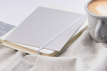 light grey note book white envelope mug with coffe light grey work feminine workspace minimalistic