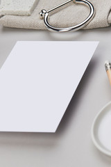 white paper flatlay wedding invitation feminine minimalistic work business pencil jewelry silver light grey