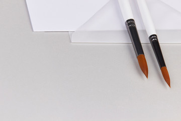 watercolor acrylic brush transparent paper envelope white silver working flatlay artist minimalistic light grey