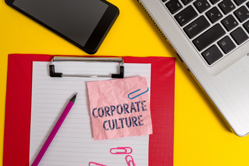 Word writing text Corporate Culture. Business photo showcasing pervasive values and attitudes that characterize a company Laptop clipboard sheet clips pencil note smartphone colored background