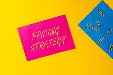 Conceptual hand writing showing Pricing Strategy. Concept meaning set maximize profitability for unit sold or market overall Blank paper sheets message reminder clips binders color background