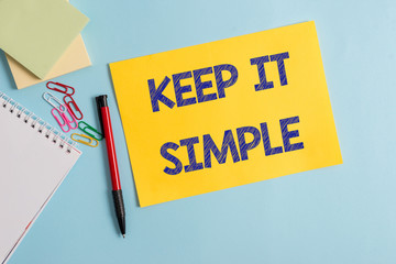 Writing note showing Keep It Simple. Business concept for to make something easy to understand and not in fancy way Plain cardboard and writing equipment placed on pastel colour backdrop