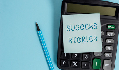 Conceptual hand writing showing Success Stories. Concept meaning life of rule models from how he started to his death Electronic calculator sticky note marker colored background