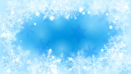 Fototapeta na wymiar Christmas blurred background with frame of complex defocused big and small snowflakes in light blue colors with bokeh effect