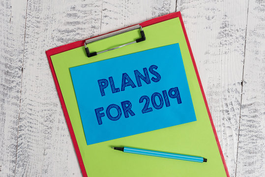 Text sign showing Plans For 2019. Business photo showcasing an intention or decision about what one is going to do Colored clipboard blank paper sheet marker sticky note wooden background