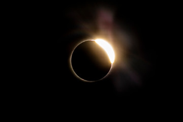 The Baily's beads effect and Diamond Ring effect during Total Solar Eclipse Chile 2019, amazing view of the Sun covered by the Moon during totality phase while the last sunbeams pass the Moon craters