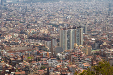 Fototapeta premium Barcelona, Spain - April, 2019: View of Barcelona city and costline in spring from the Bunkers in Carmel neighborhood. Few building stand out like sagrada familia and Agbar tower