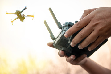 hands with remote controller of drone outside. © BNMK0819