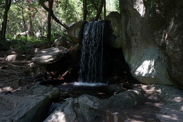 artificial waterfall in the Park in summer
