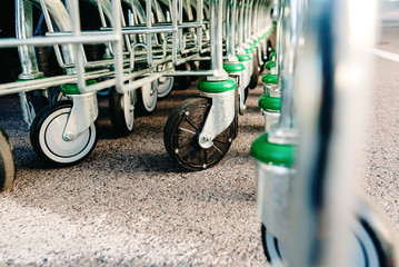 Detail of the plastic wheels of shopping carts in a supermarket lined up.
