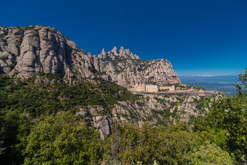 Fototapeta na wymiar Aerial view on Santa Maria de Montserrat Abbey in Montserrat mountains, Spain