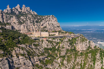 Fototapeta na wymiar Aerial view on Santa Maria de Montserrat Abbey in Montserrat mountains, Spain