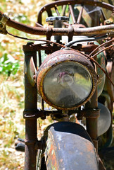 Old rusty motorcycle headlight.