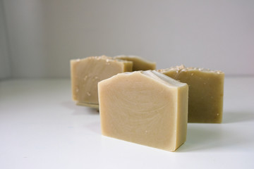 Natural oatmeal soap is placed on a white background.