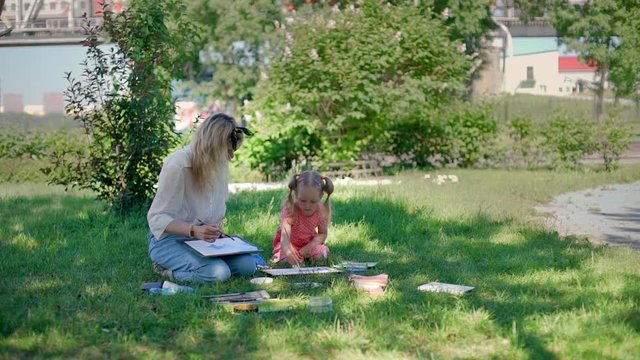 Little Girl with Teacher at Painting Lesson Outdoors. Watercolor Paint with Teacher in Nature. Creativity Inspiration Expression Concept