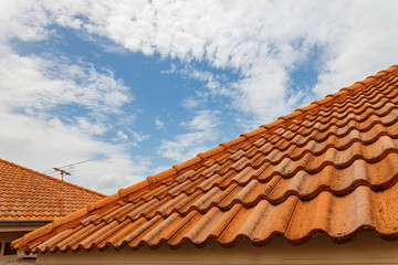 Close up of brown clay roof tiles. Red old dirty roof. Old roof tiles. Construction equipment build...