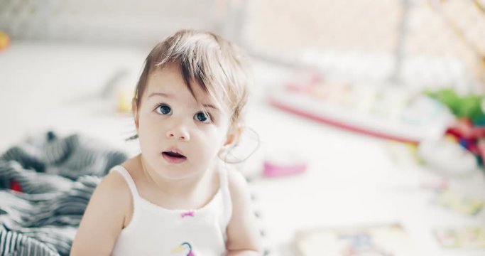 Incredible cute baby girl playing indoors. Shot on a cinema camera in 4K RAW.