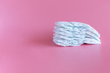 Some baby diapers on a Pink Background