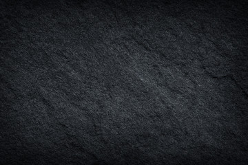 Dark grey / black slate background or texture.