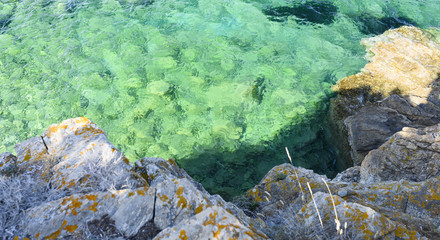 Stunning view of a rocky coast bathed by a turquoise clear water, Emerald coast Sardinia, Italy.
