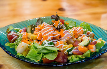 Japanese spicy salad sashimi salmon with Premium fresh raw salmon. Asian salad with tofu and fresh vegetables Mixed sliced fish sashimi, thin sliced raw meat salmon , tuna, Sashimi is a Japanese.