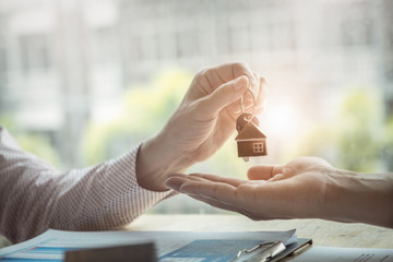 Real estate agents agree to buy a home and give keys to clients at their agency's offices....