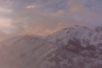 Winter sunset in the Andes mountains with fog in the valley