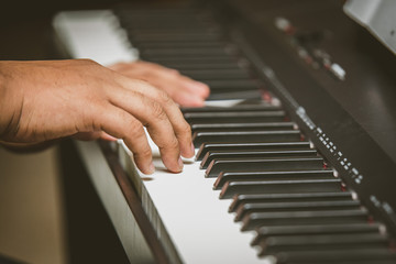Fototapeta na wymiar Selective focus Man hand playing piano