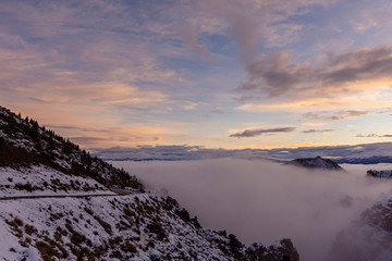 Winter sunset in the Andes mountains with fog in the valley