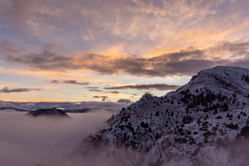 Winter sunset in the Andes mountains with fog in the valley