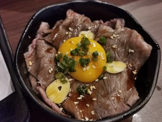 Beef over rice on top with raw egg