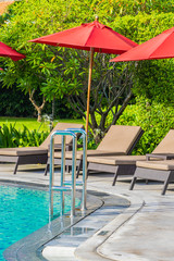 Beautiful umbrella and chair around outdoor swimming pool in hotel resort for holiday vacation travel