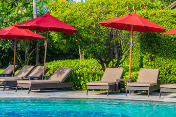 Beautiful umbrella and chair around outdoor swimming pool in hotel resort for holiday vacation travel