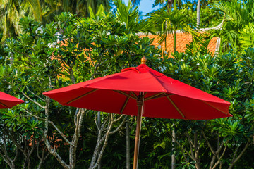 Beautiful umbrella and chair around outdoor swimming pool in hotel resort for holiday vacation travel