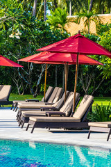 Beautiful umbrella and chair around outdoor swimming pool in hotel resort for holiday vacation travel