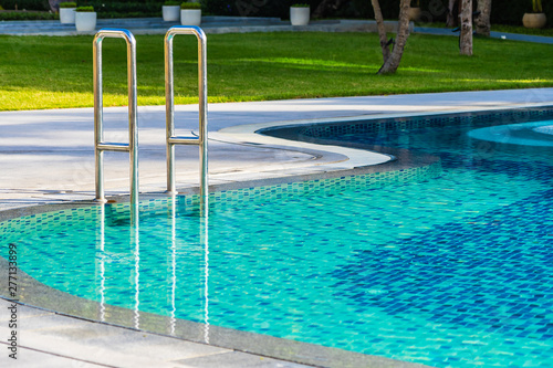 Beautiful Umbrella And Chair Around Outdoor Swimming Pool In