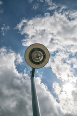 light post in front of a cloudy sky