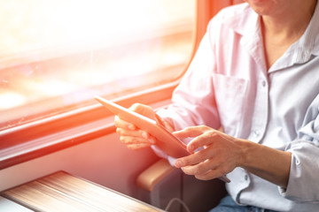 Business man using computer tablet working in metropolitan railway train commuter. Work from...